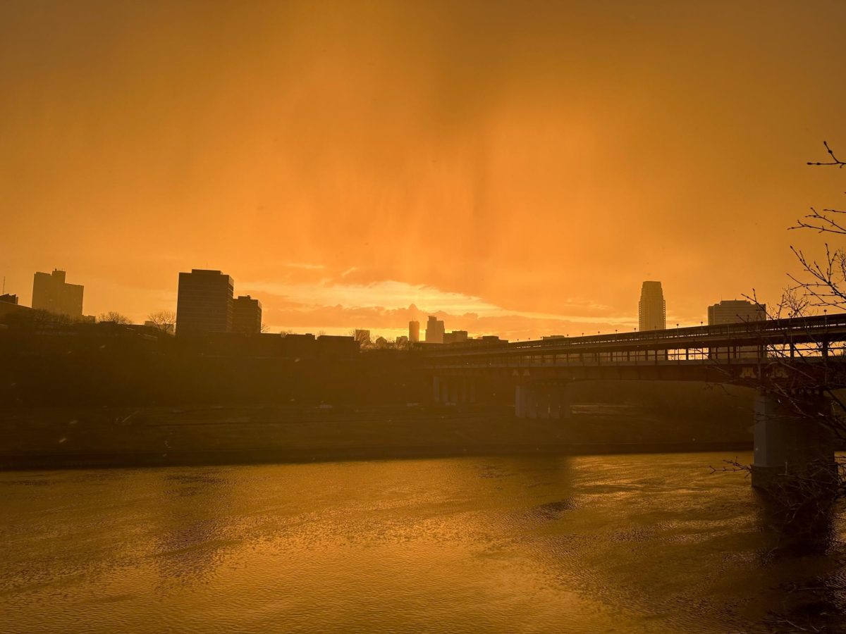 An orange sunset illuminates the Minneapolis skyline April 11 as rain begins to fall on the University’s East Bank.