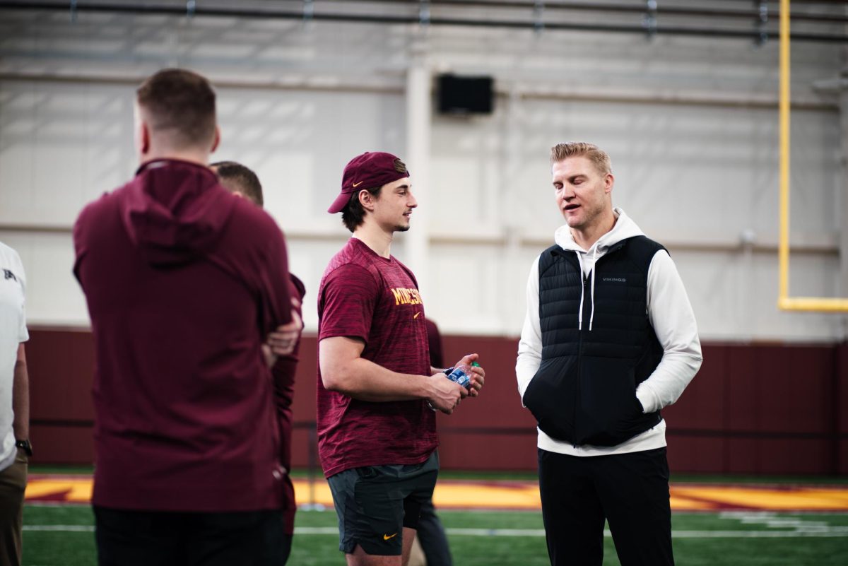 Quarterback Max Brosmer (left) and Minnesota Vikings quarterback coach Josh McCown (right) during  is on the right during the Gophers Pro Day on March 14. In 11 games played, Brosmer was second in the FCS in passing yards (3,449) and first in yards per game (313.6).