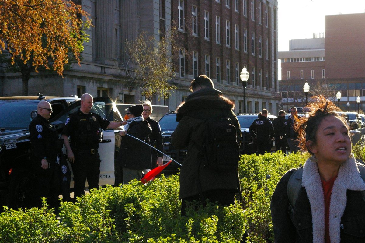 Students and community members react as cops shut down a pro-Palestinian protest in front of Northrop at 7:40 a.m. on Tuesday.