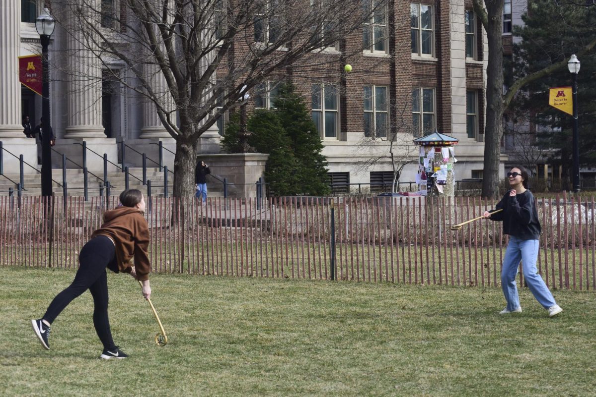 Students Sarina and Aloria play traditional great lakes lacrosse, enjoying the weather at The Mall on Thursday.