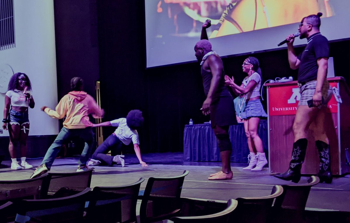 (From left to right) Mamé 007, Wari 007, Yoni Light and Don T., members of the Minneapolis ballroom collective Vogue Down, encourage two audience members battling in the performance category as part of their showcase on Friday, June 28.