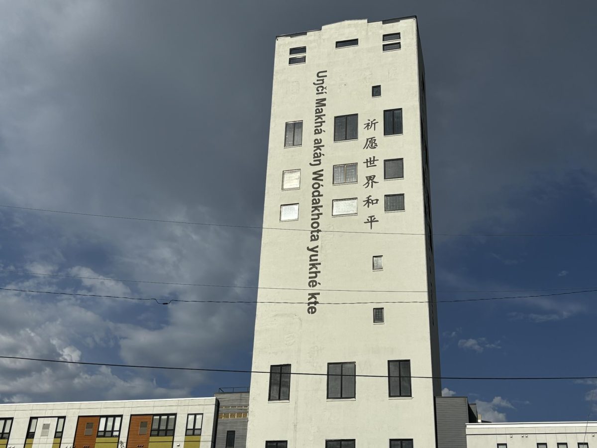 The words “May Peace Prevail On Earth” are painted on the side of the building in six different languages. 