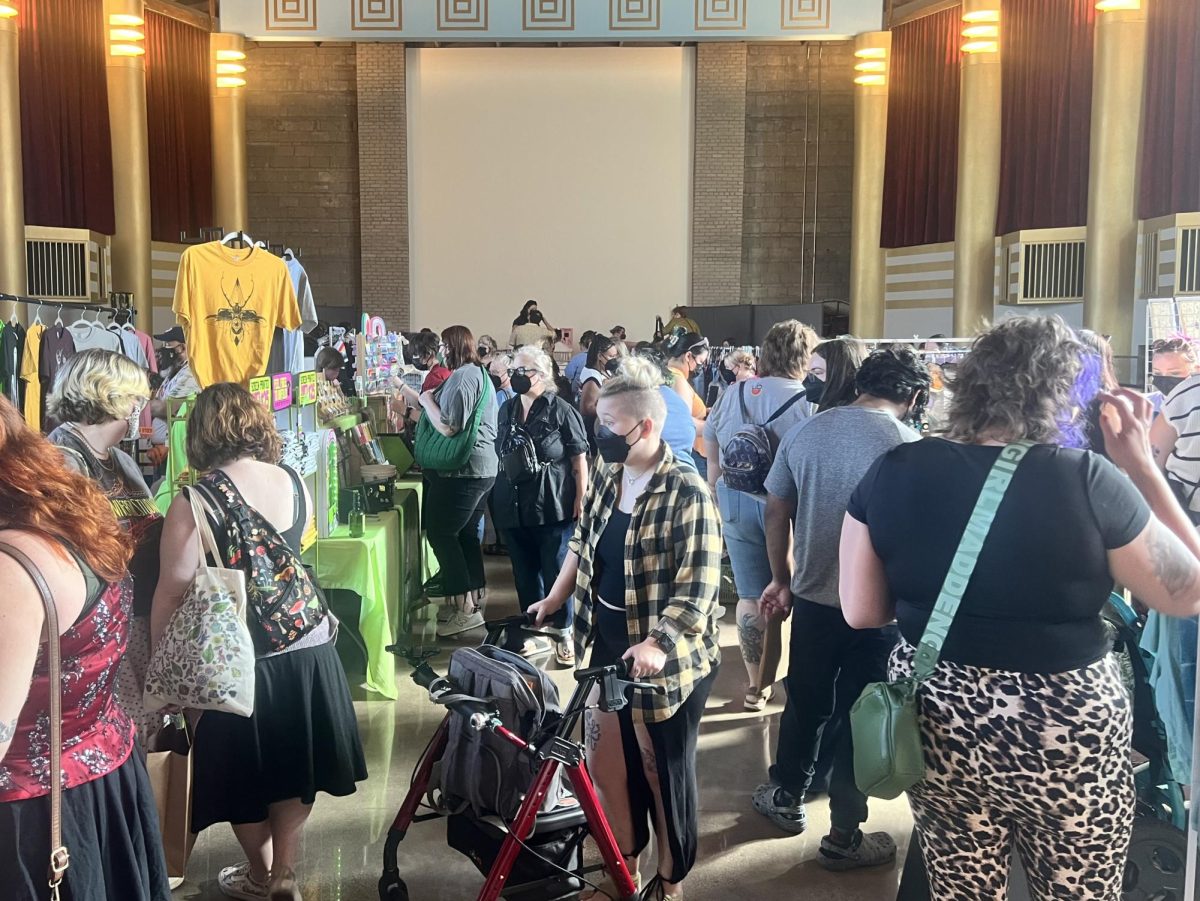 Customers move about the booths at Fat Flea on Saturday, shopping through clothing, artwork and more.