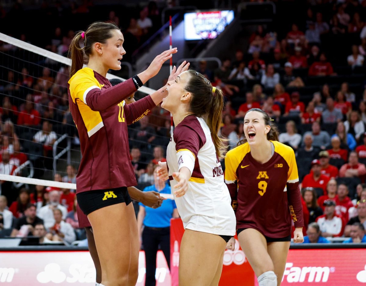 Gophers embrace each other after defeating No. 1 Texas.