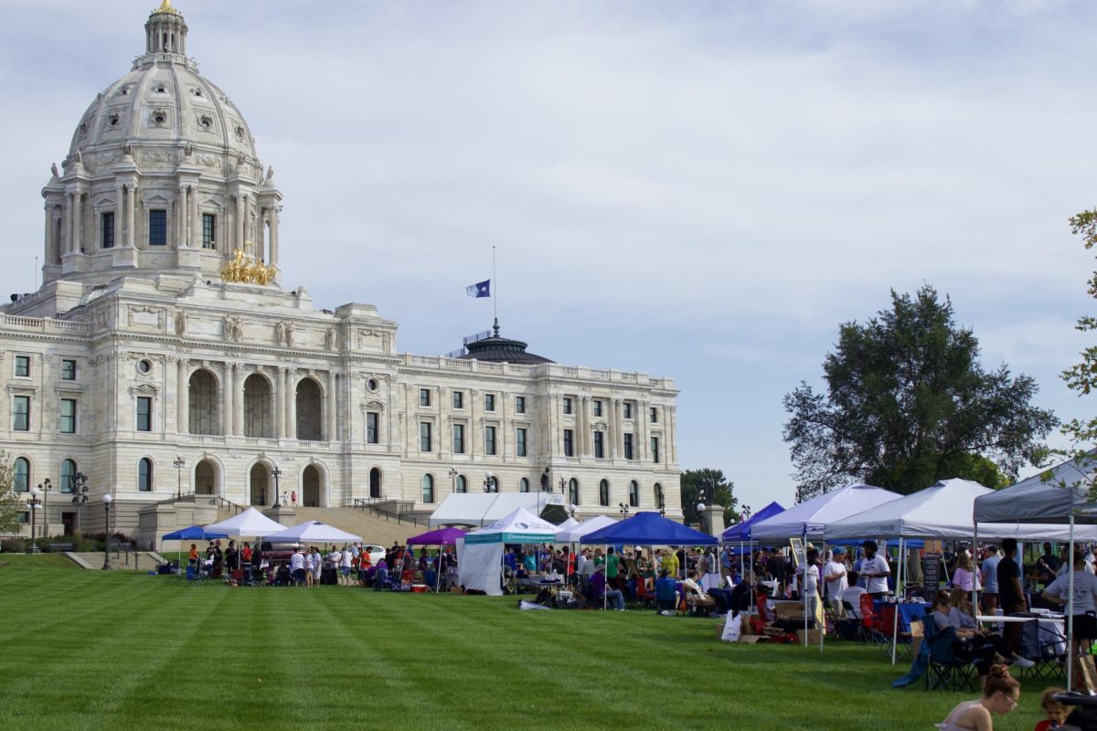 Organizations table as attendees walk through the Capitol lawn.