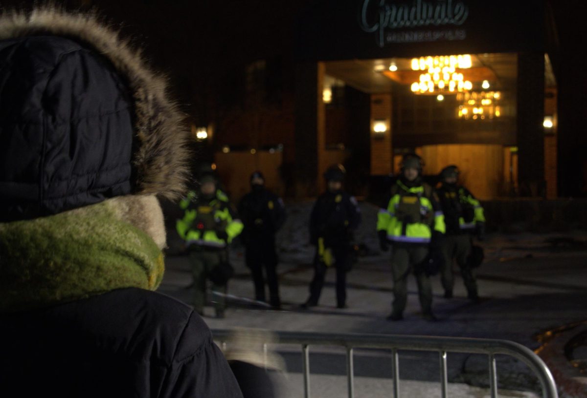 Law enforcement stood across from protesters outside of the Graduate Hotel Wednesday night. 