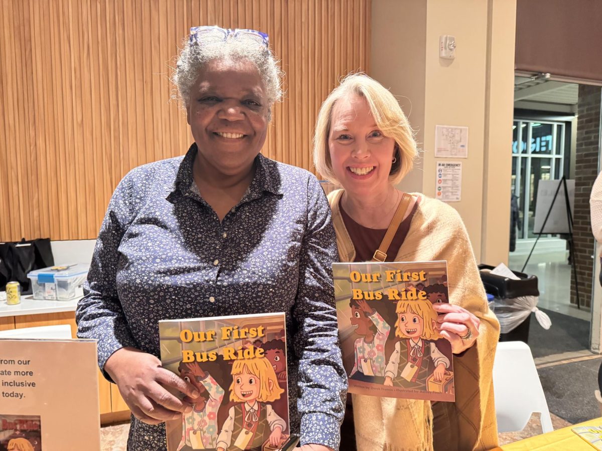 Monica Lash and Molly Johnson students involved in the 1971 Hale-Field school integration, pose holding Derek Francis’ book Our First Bus Ride during a Black History Month event in St. Paul.