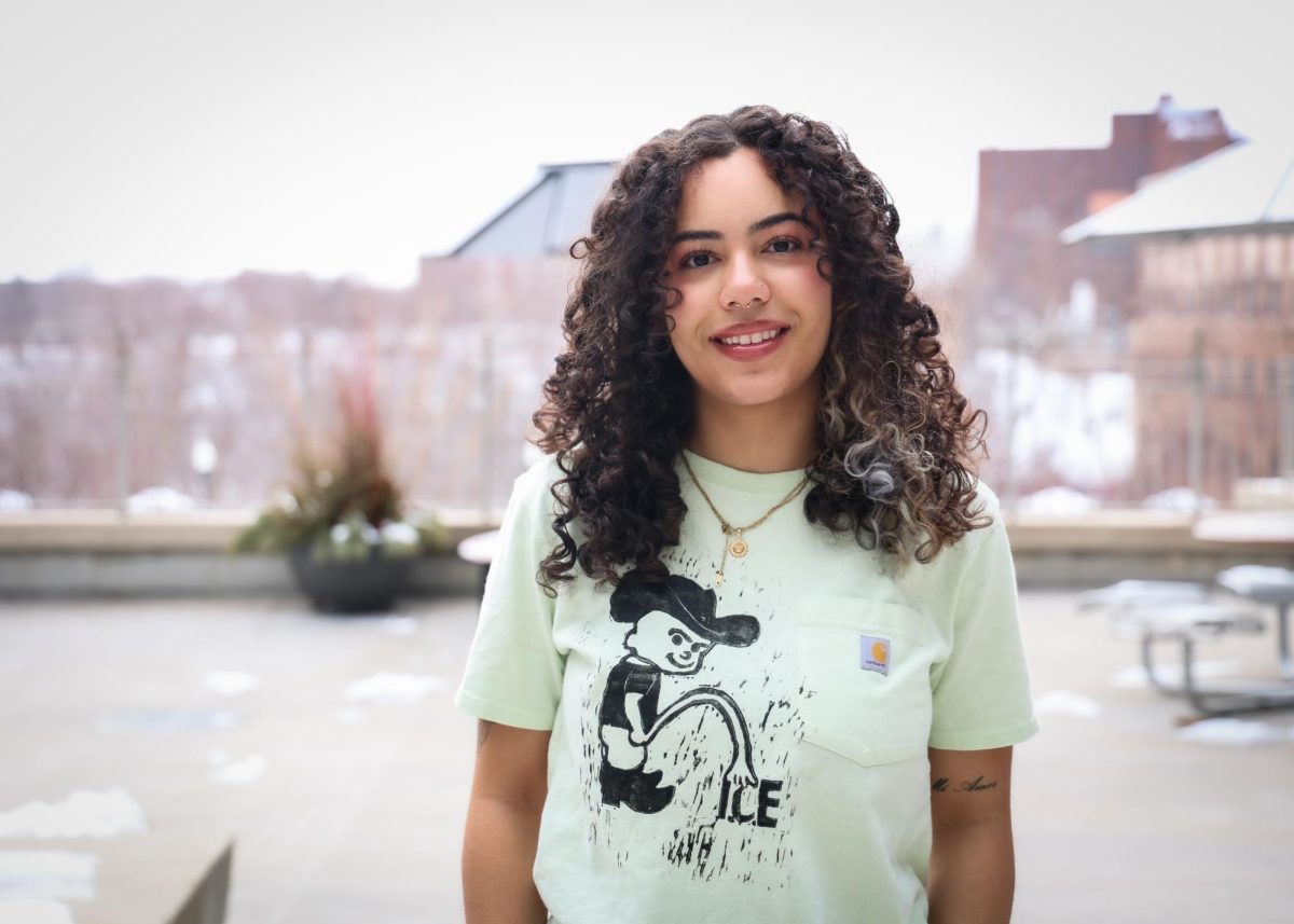 Soleil Anthony poses wearing one of the shirts she printed using the woodcut relief process.