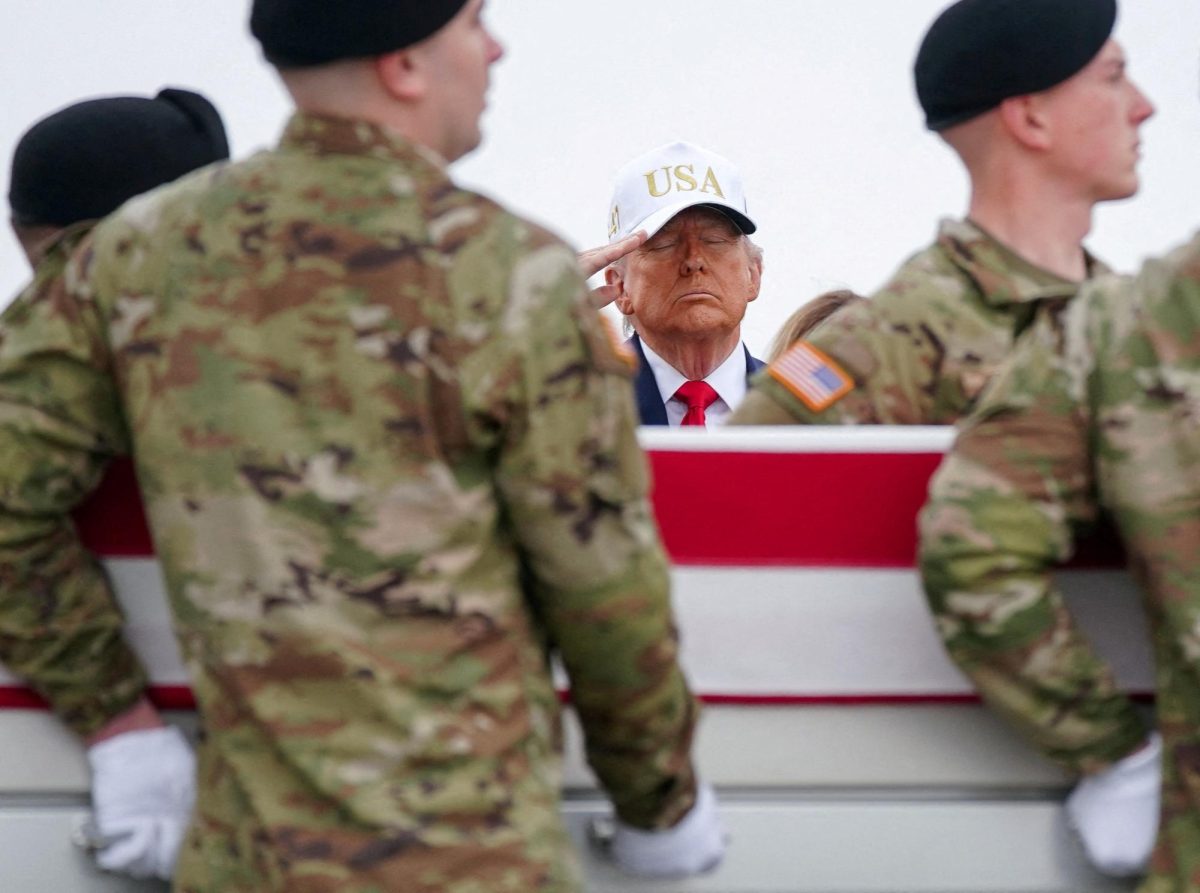 U.S. President Donald Trump salutes as members of the military carry a transfer case during a dignified transfer of the remains of six U.S. Army service members of the 103rd Sustainment Command, who were killed in Kuwait, Major Jeffrey O'Brien, Capitain Cody Khork, Chief Warrant Officer 3 Robert Marzan, Sergeant 1st Class Nicole Amor, Sergeant 1st Class Noah Tietjens and Sergeant Declan Coady, amid the U.S.-Israeli conflict with Iran, at Dover Air Force Base in Dover, Delaware, U.S., March 7, 2026. | REUTERS