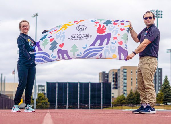 Athlete Lucy Haugland, with Special Olympics USA Games board member David Booth, April 9, 2026. Haugland will be competing in track and field at the 2026 games hosted by the University.
