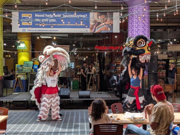 Two members of the North Star Lions perform traditional Chinese lion dancing during the Midtown Arts and Music Festival on June 13.