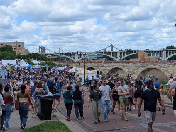 Festival attendees engage in activities along West River Parkway next to the historic Stone Arch Bridge on June 20.