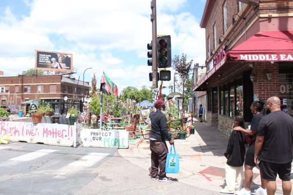 Marquise Bowie gives a tour of George Floyd Square to the Patterson family. Minneapolis, MN. June 25, 2026.